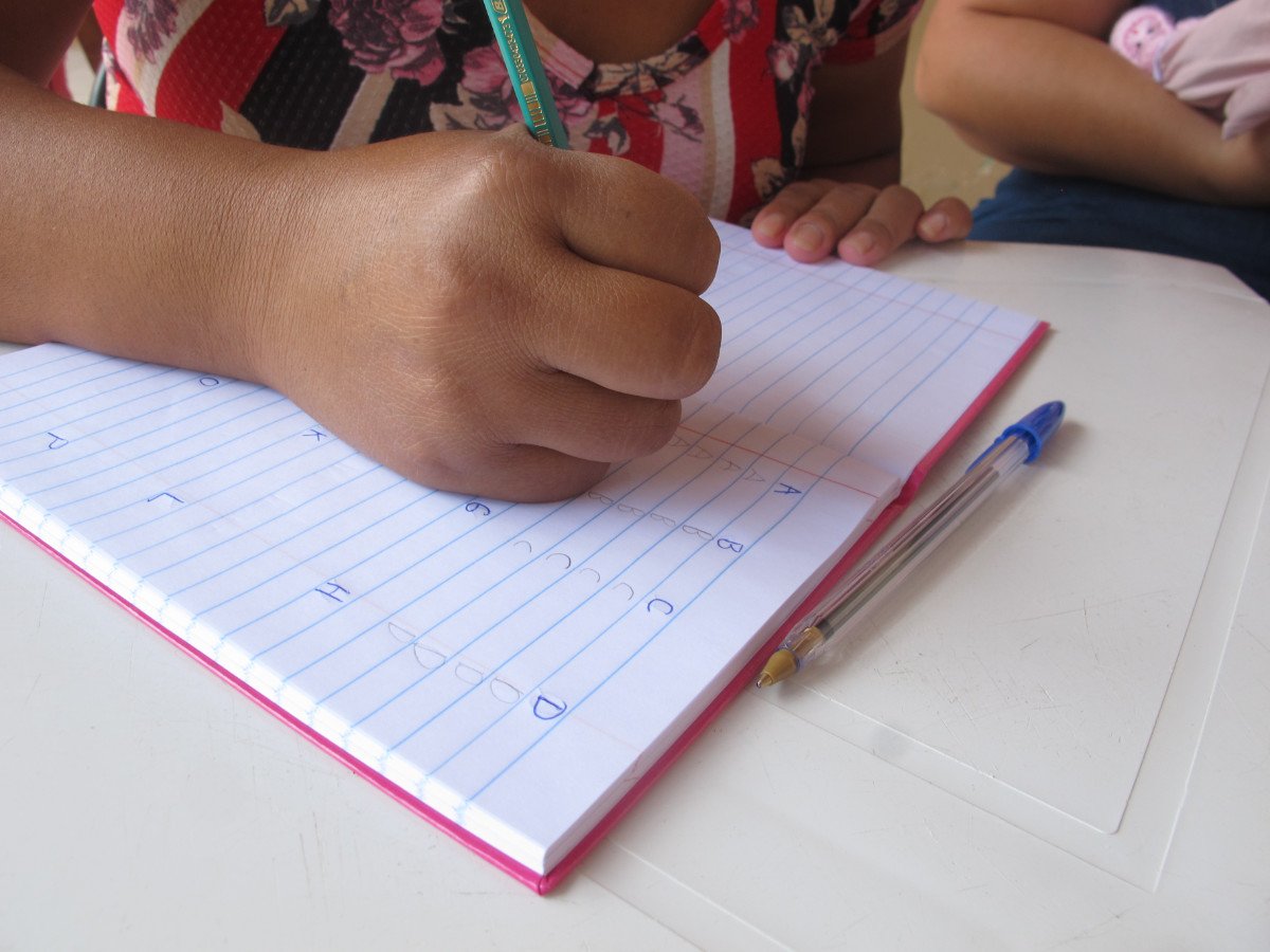 mao caderno e caneta